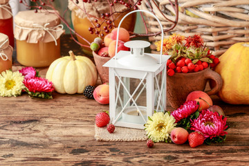 Fototapeta na wymiar Vintage iron lantern among autumn fruits, vegetables and plants.