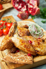 Grilled chicken on a wooden board with vegetables 