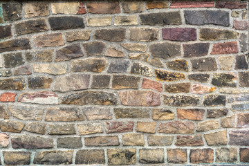 Stone texture. Colorful rock wall. Wall of colored stones bonded with cement.