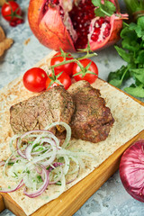 Wooden board with meat from a barbecue,