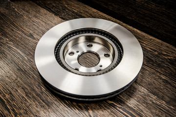 Car brake diske on wooden background