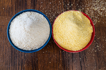 Two bowls of yellow and white Nigerian Garri on Table