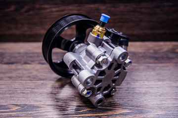 Power steering pump on wooden background