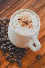 Hot coffee  with milk foam on top , coffee drink time