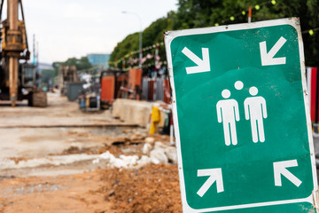 Assembly Point signage with construction site background