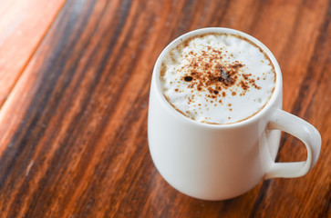 Hot coffee  with milk foam on top , coffee drink time