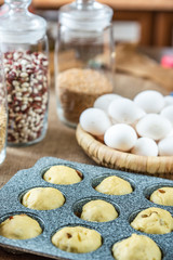 Raw dough in cupcake baking dish.