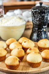 Baked muffins on a wooden plate