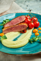 Fried meat with shredded potatoes and tomatoes 