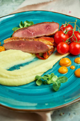 Fried meat with shredded potatoes and tomatoes 