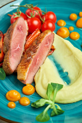 Fried meat with shredded potatoes and tomatoes 