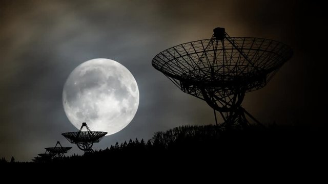 Westerbork Synthesis Radio Telescope (WSRT) by Night with Full Moon and Clouds in Time Lapse, Netherlands