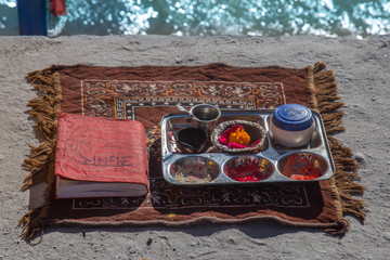 Holy book and pooja thali near ganga ghat