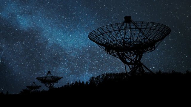 Westerbork Synthesis Radio Telescope (WSRT) by Night with Stars, Milky Way and Radars in Silhouette, Netherlands