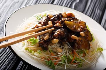 Vietnamese style rice vermicelli with vegetables and caramelized eggplants close-up on a plate. horizontal