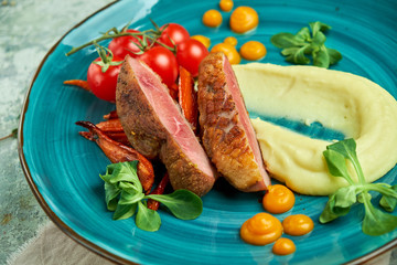 Fried meat with shredded potatoes and tomatoes 