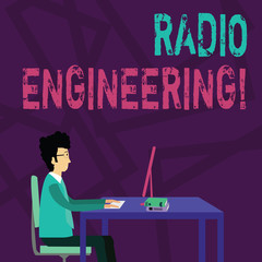 Handwriting text Radio Engineering. Conceptual photo Concerned with the operation and repair of radio equipment Businessman Sitting Straight on Chair Working on Computer and Books on Table
