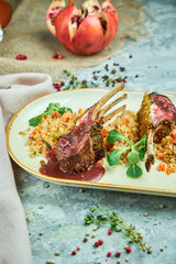 grilled lamb chops and risotto on a plate 