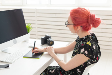 Graphic designer, people concept - Young designer female hipster with graphic tablet working in...