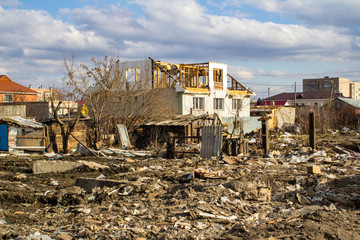 The destruction of the walls of the old building and the cleaning of construction debris with a...