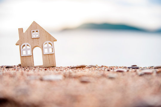 The symbol of the house standing on the seashore 