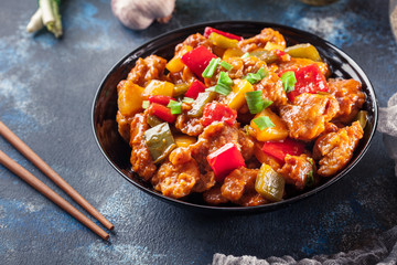 Sweet and sour chicken with colorful bell pepper on a plate