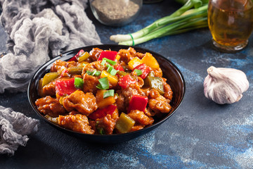 Sweet and sour chicken with colorful bell pepper on a plate
