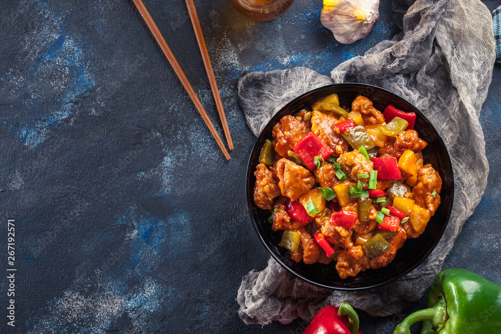 Wall mural sweet and sour chicken with colorful bell pepper on a plate