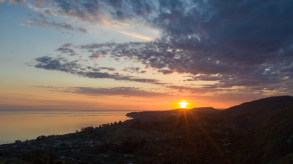 Aerial photography. Evening view of the sea and shore. Sunset over the water. Clouds in the sky.