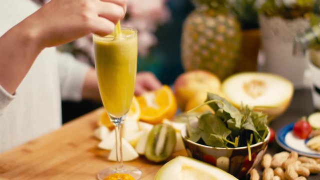 Mixing vegan juice made from organic fruits