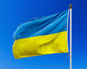 Ukrainian flag on the blue sky. Isolated with clipping path.
