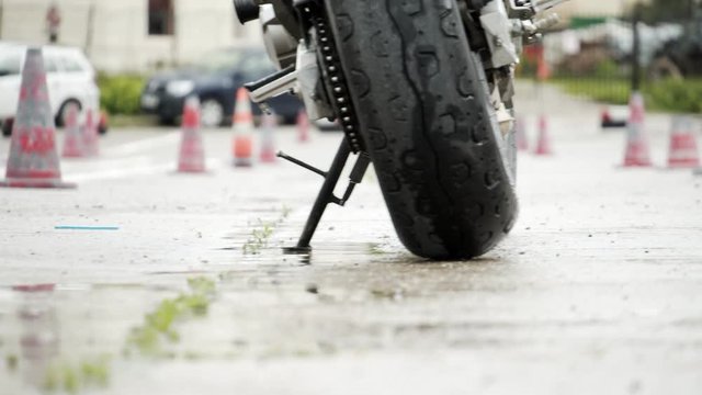 Driving school with cones and motorcycle in a poor country.