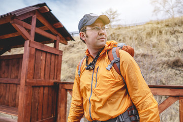 Tourist Hiking with an orange backpack is on the platform of the old railway. Travel to lake Baikal