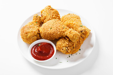 Crispy  fried chicken drumsticks on white table.