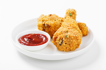 Crispy  fried chicken drumsticks on white table.