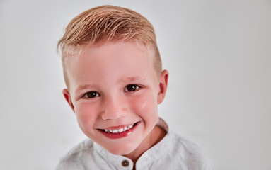 Little boy on gray background