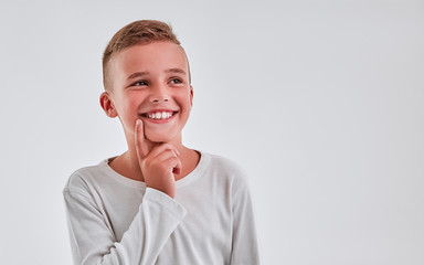Cute boy on a gray background