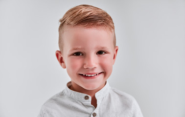 Little boy on gray background