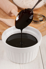 Blackstrap molasses or treacle a viscous dark sugar syrup produced from sugar cane and used as a sweetener in baking and cooking