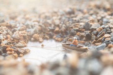 Miniature People, Miniature fishermen are fishing by boat 