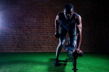 Fototapeta na wymiar young muscular african american man doing push-ups and looking away