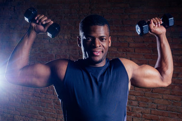 Fototapeta na wymiar muscular african american man exercising with dumbbell