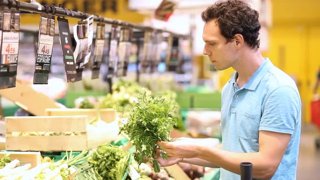 people buying fresh local bio vegetables in grocery store or supermarket