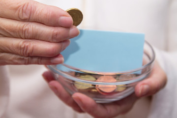 hands with jar of coins and savings sign, concept of savings, pensions and retirement