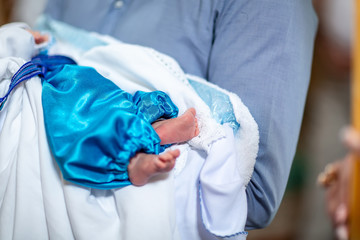 Infant baptism. baby preparing for a baptismal ceremony, The sacrament of baptism. Attributes of an...