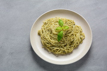 Pasta spaghetti with pesto sauce, fresh basil and cherry tomatoes . Italian traditional food