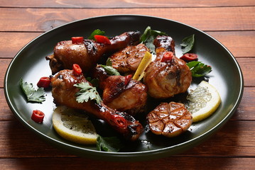 Grilled chicken legs with spices, parsley, garlic and lemon. Barbecue chicken concept 