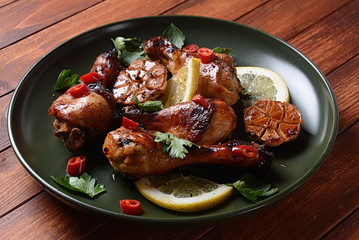 Grilled chicken legs with spices, parsley, garlic and lemon. Barbecue chicken concept 