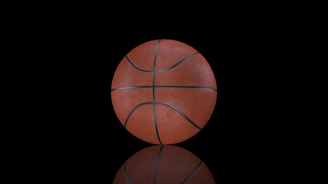 3D animation, basketball ball rotating in place on mirror surface.
