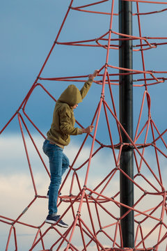 Boy climbing ropes